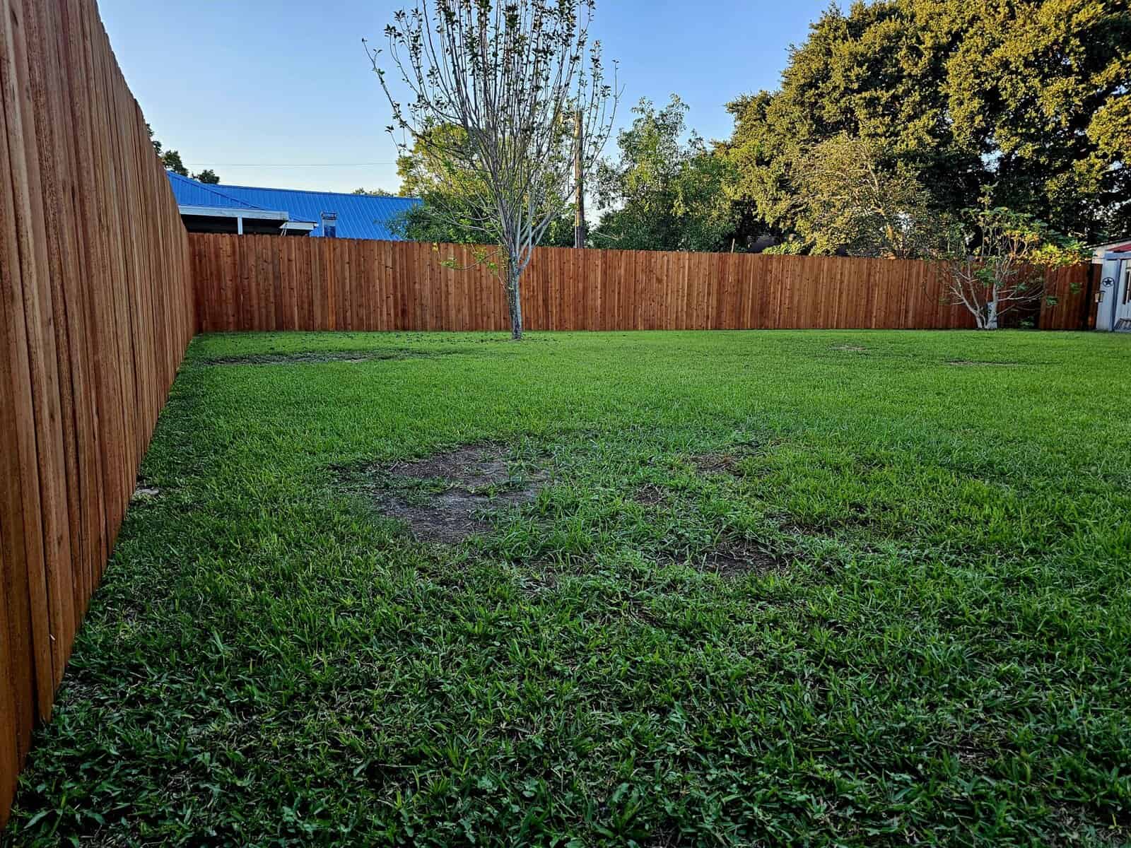 Pre-stained wood fence installation in Lafayette LA by Lafayette Fence and Gate