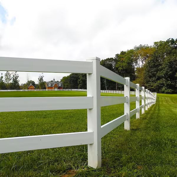 White fence along green grassy field